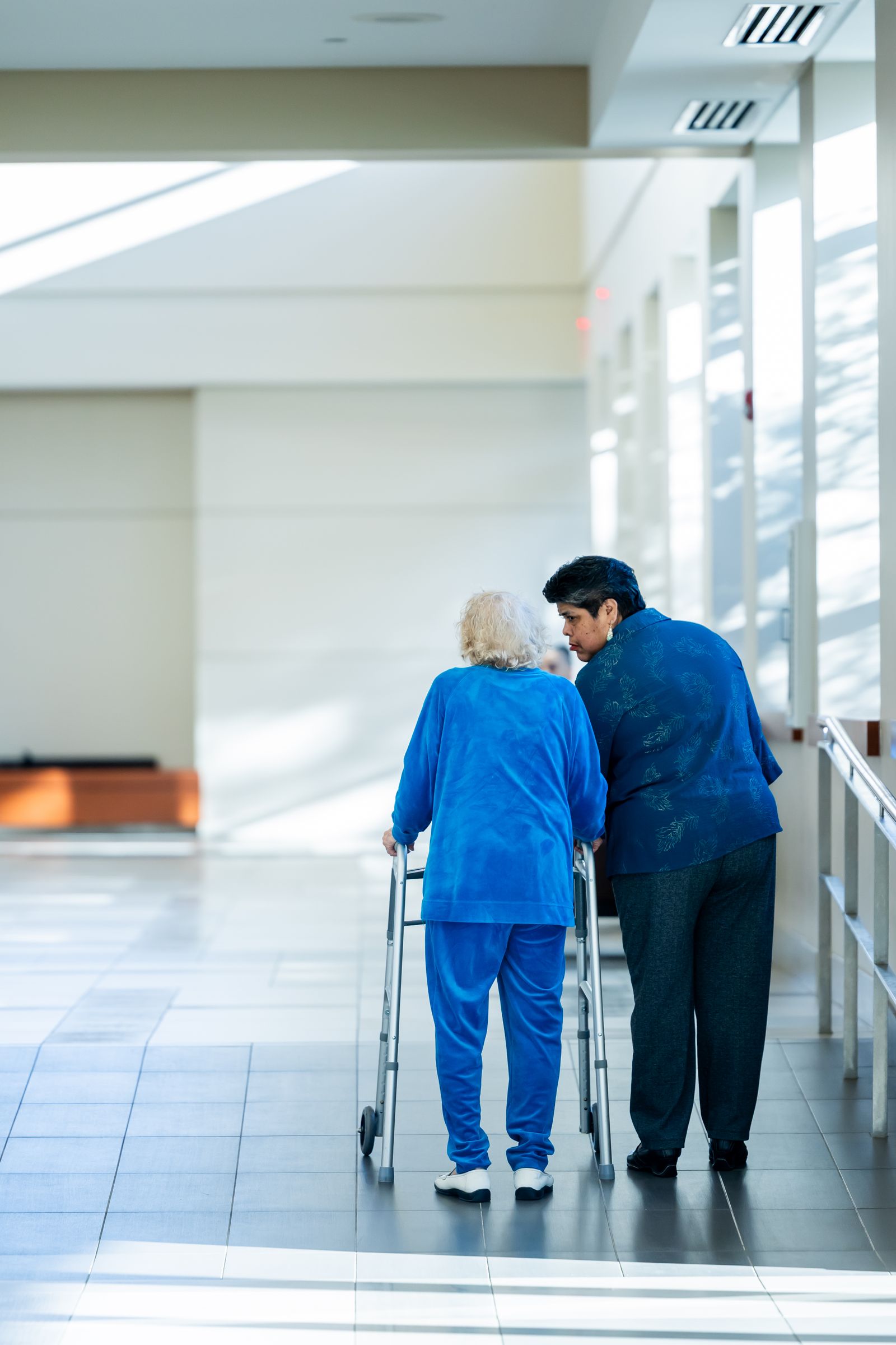 Care worker offering warm, attentive support to an older woman
